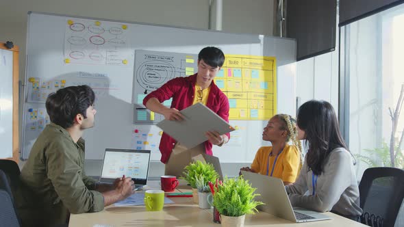 Meeting of UX developer and UI designer brainstorming about mobile app interface workflow alt