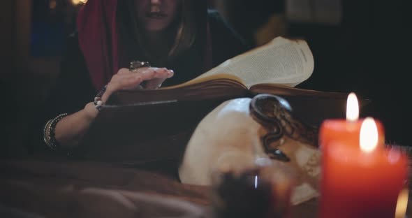 Young Dark Witch Reading Magic Book Looking for Spell alt