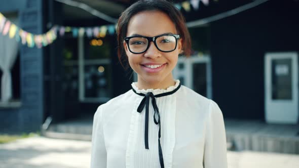 Slow Motion Portrait of Young African American Student Smiling Outdoors alt