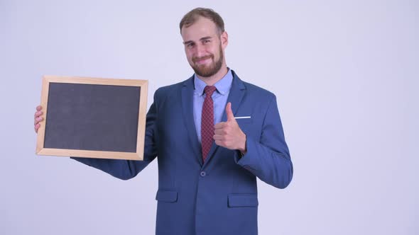 Happy Bearded Businessman Holding Blackboard and Giving Thumbs Up
