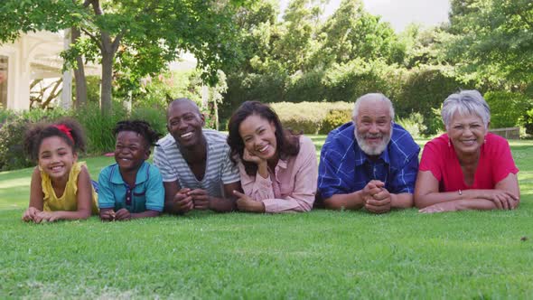Multi-generation African American family spending time in garden together alt