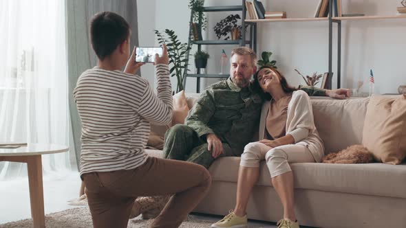 Boy Taking Photo of his Mother and Father alt