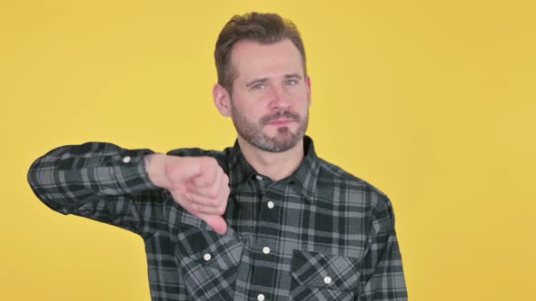 Portrait of Middle Aged Man Showing Thumbs Down Gesture alt