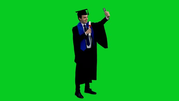 Graduate Student In Black Gown Posing with Diploma for Taking Selfie
