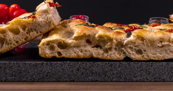 Homemade italian flat bread - Focaccia contorta. With olives, olive oil, rosemary, tomatoes. Traditi alt