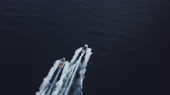 Two high-speed motorboats ride along a beautiful bay in the Black Sea in 4k resolution