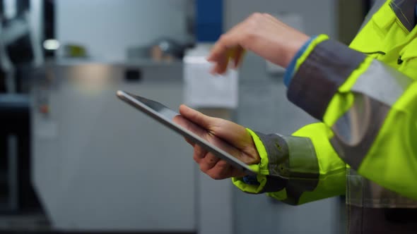Closeup Hands Holding Tablet Computer at Modern Huge Special Facility Storage alt