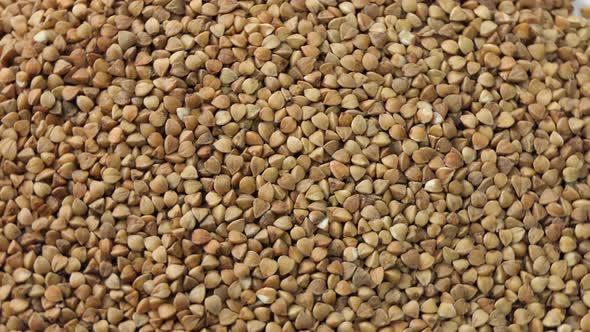 Dry Uncooked Brown Buckwheat Groats Rotating Buckwheat Grains Product alt