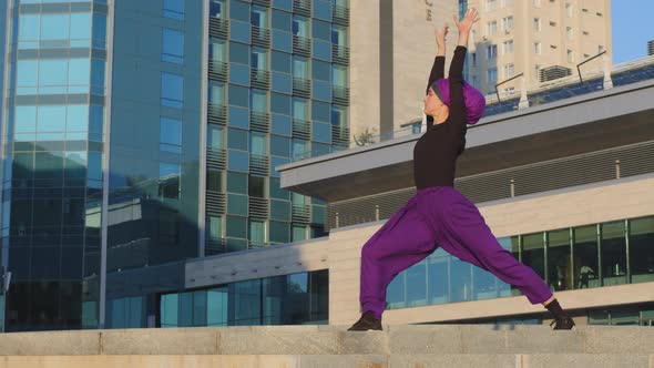 Active Sportive Woman in Hijab Strong Girl Trainer Yogi Stands in City Outdoors on Background of alt