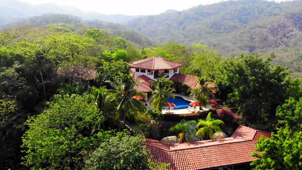 Aerial drone shot flying away from Los Altos de Eros in Tamarindo, Costa Rica. alt