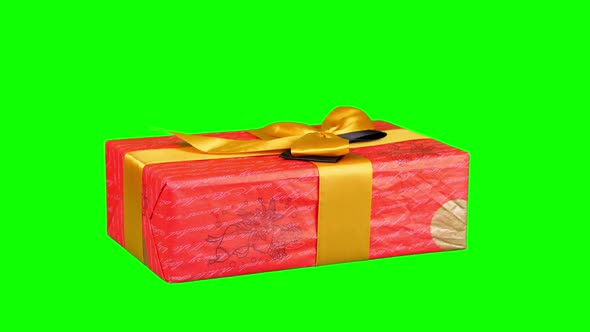 Beautifully Wrapped Gift, Present Isolated on Green Background. Close-up, Rotation. Christmas or New alt