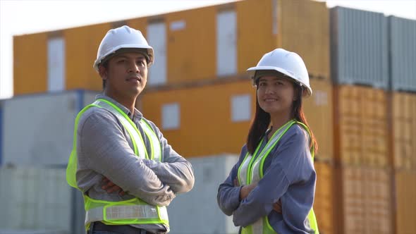 Two logistic staff checking and control loading containers box from cargo