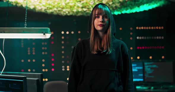 Portrait of a Young Hacker Looking at the Camera in a Secret Hideout In the alt