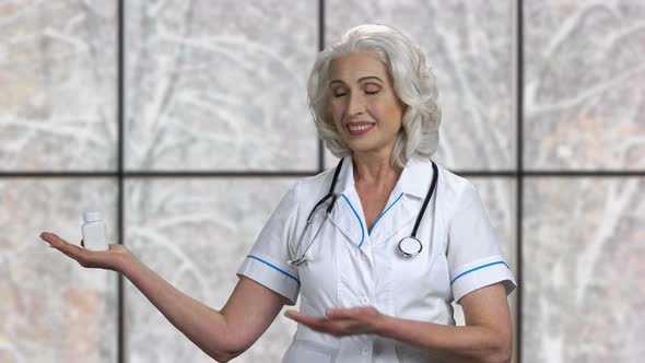 Beautiful Woman Doctor Presenting Pills alt