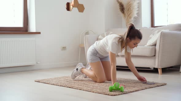 Young Healthy Caucasian Woman Workout at Home Does Plank Exercise on Mat