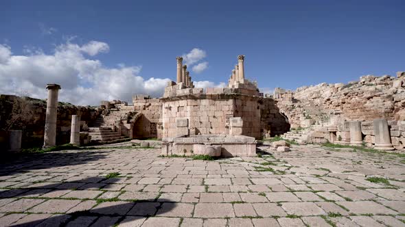 Ruins of Ancient Stone Church with Well and Curved Stairs in Roman Ruins in Jerash alt
