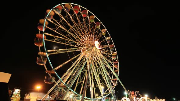 Time-lapse of Ferris Wheel at amusement park at a night time
