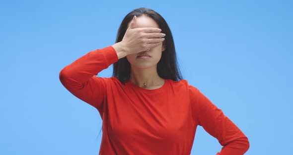 Young Woman Covering Eyes alt