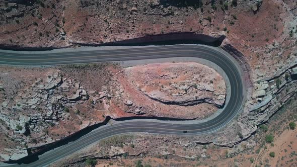 Drone view of road with sharp curves and traffic near Moab
