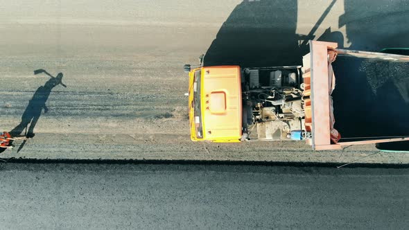 Top View of Road Workers Coming To the Truck with Bitum. Road Construction Site. alt