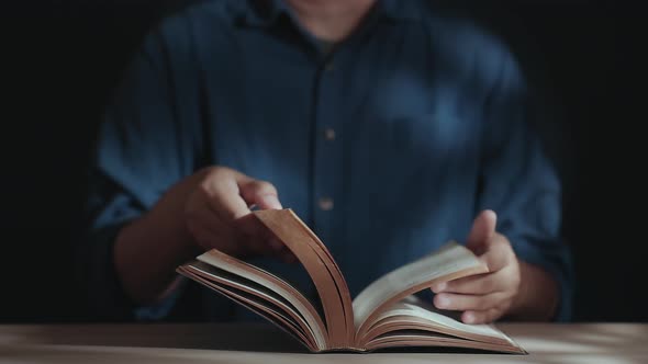 Spirituality and Religion Concept, Person Sitting on Desk to Making Pray on a Holy Bible