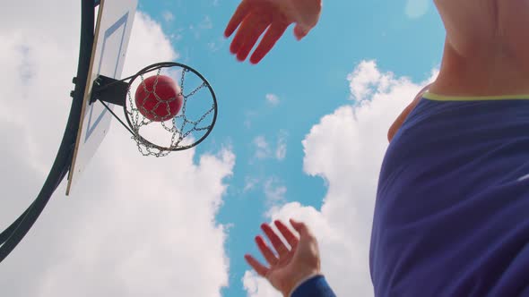 Upward View of Focused Senior Player Man Playing Basketball Game Successfully Hits Into Basket Ring alt