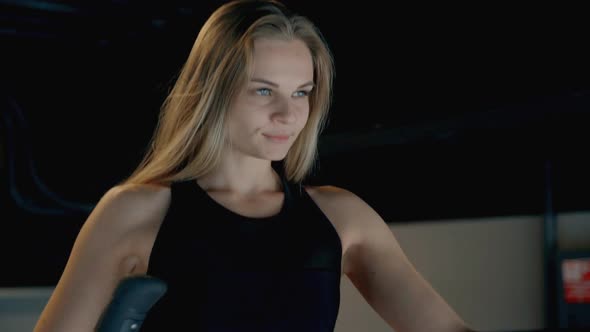 Woman Doing Workout on Orbitrek in Gym