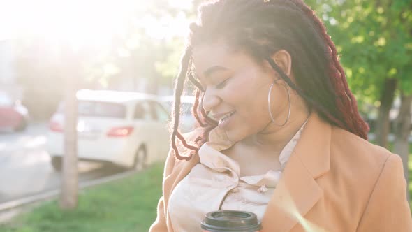 Smiling Attractive Young African American Woman Standing in the Street alt