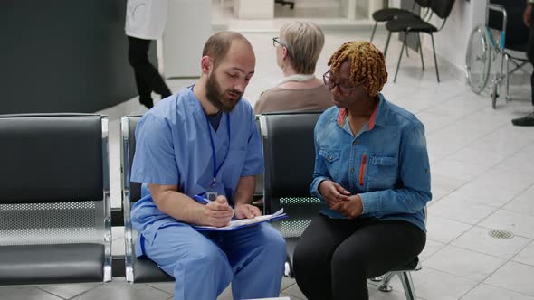 African American Patient Talking to Male Nurse About Medical Support alt