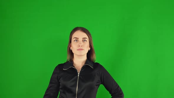 Woman Presses Virtual Buttons on a Green Screen alt
