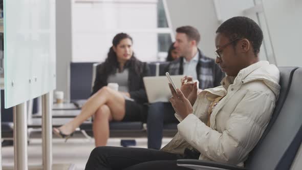 Woman using cell phone at airport