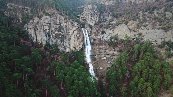 Beautiful Aerial Waterfall with Rocks in a Mountain alt
