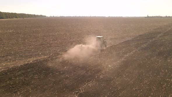 Slow Motion Drone View of Tractor Plowing Farm Field alt