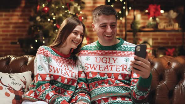 Couple Using Smart Phone Talking to Family Congratulates Merry Christmas by Video Call Conference alt