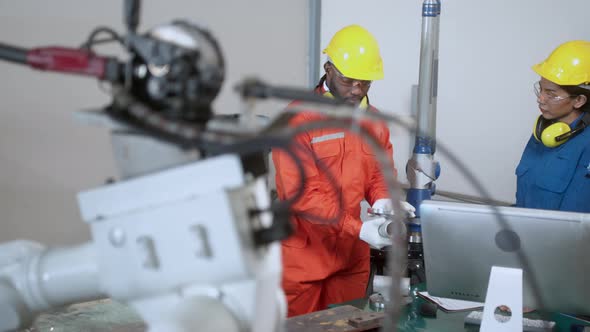 engineer cooperation male and female technician maintenance control relay robot alt