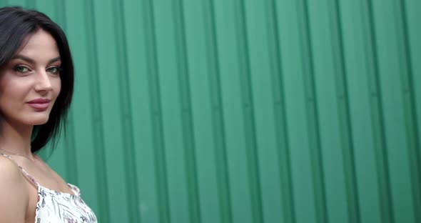 Stunning Brunette Poses with Blowing Hair at Camera on Background Outdoors alt