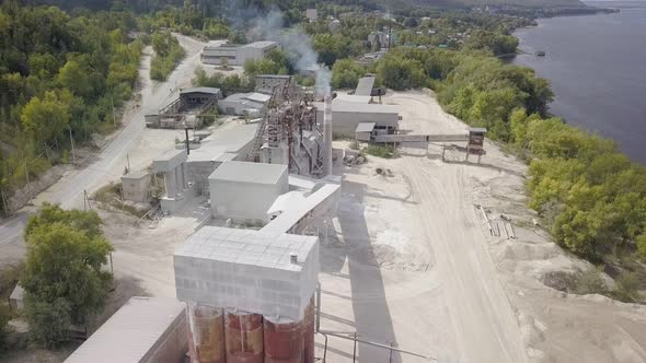 Camera Is Flying Up Over Plant of Processing of Limestone in Summer Day