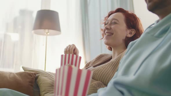 Woman Eating Popcorn Laughing alt