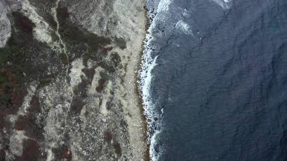 Shooting From Helicopter Flying Over Natural Coastline with Wavy Sea and Cliff Rocky Terrain alt