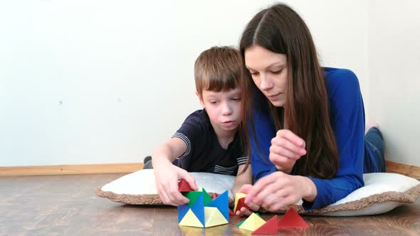 Mother and Son Are Building From Plastic Constructor with Non-ferrous Magnetic Triangles.