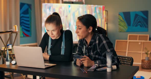 Talented Hardworking Painters Spend Evening Late at Work Sitting in Front of Laptop Screen Ordering alt