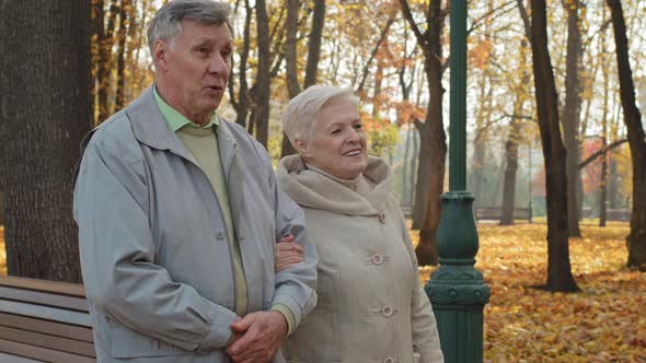 Happy Caucasian Family Walking in Autumn Park Together Enjoy Free Time Outdoors Mature Aged Smiling alt