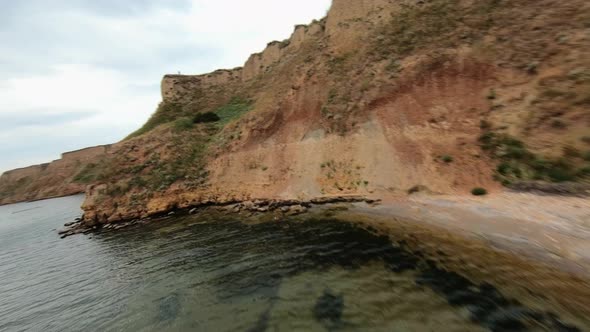 FPV Flight Over a Coastal Cliff at Cloudy Day alt