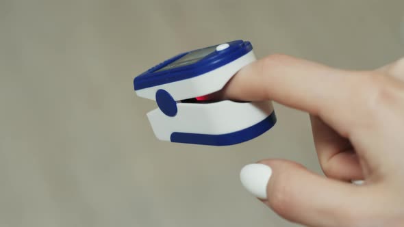 Closeup on a Finger in a Pulse Oximeter alt