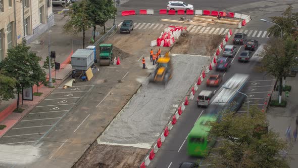 The Bulldozer Moves and Spreads the Soil and Rubble on the Road Timelapse. alt