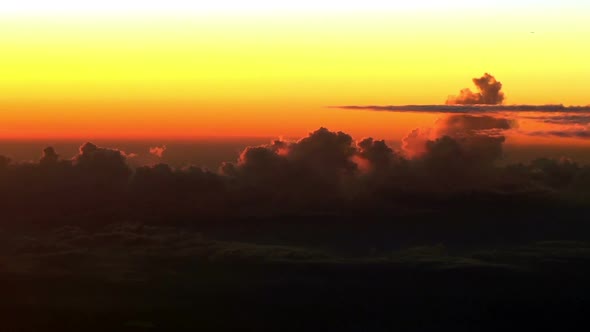 Colorful sunset clouds. Actual airplane cockpit view, high altitude footage.