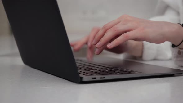 The Woman's Hands are Typing on the Laptop Keyboard