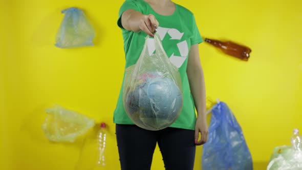 Unrecognizable Woman with Earth Globe in Plastic Package. Save Ecology. Plastic Nature Pollution alt