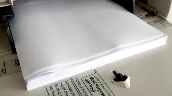 Close Up shot of Office printer document in the process are working and the sheets copier with white alt