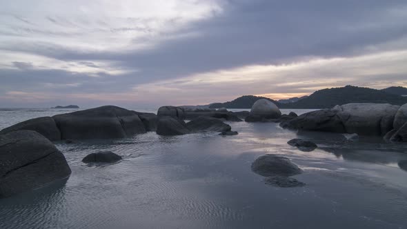 Timelapse Sunset of low tide at rocky stone of seaside alt